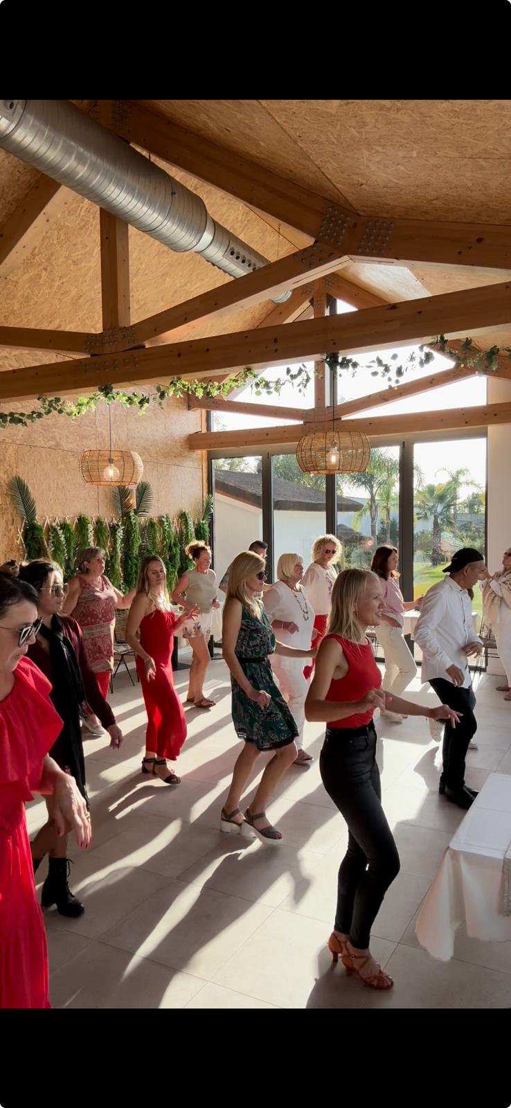 A sunny ObsessionSalsa group class dancing together